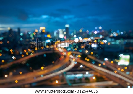 Bokeh of Bangkok skyline from above during the blue hour - Thai city scape with spectacular nightscape - defocused abstract city in the twilight.