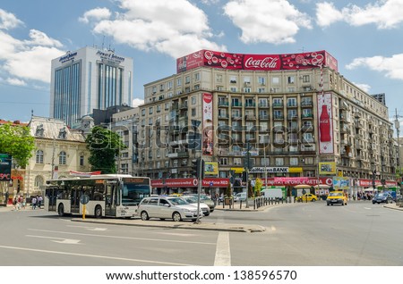 BUCHAREST, ROMANIA - MAY 15: The Roman Square on May 15, 2013 in Bucharest, Romania.  Is a major traffic intersection in downtown Sector 1 and the main building is the Academy of Economic Studies.