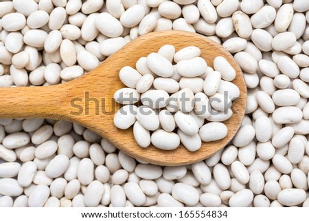 Wooden Spoon With White Beans Background