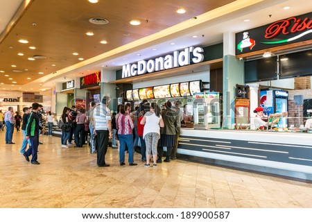 BUCHAREST, ROMANIA - APRIL 21: People buying fast-food from McDonald\'s Restaurant on April 21, 2014 in Bucharest, Romania. McDonald\'s is the main fast-food restaurant chain in Romania.