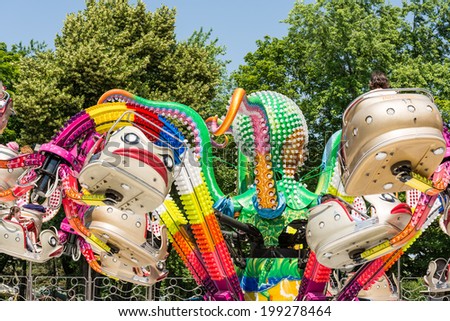 BUCHAREST, ROMANIA - JUNE 08, 2014: Children Having Fun In Octopus Ride In Amusement Park (Tineretului Park) On Summer Day. Created in 1965 is one of the largest fun parks in south Bucharest.