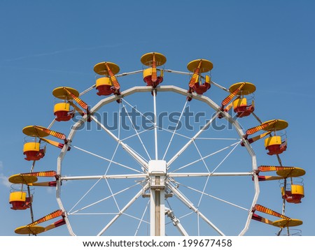 Fun Park Ferris Wheel Against Blue Sky