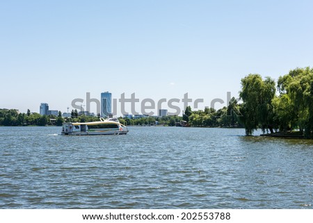 BUCHAREST, ROMANIA - JUNE 29, 2014: People Taking Boat Tour Ride On Herastrau Lake In Herastrau Public Park. Opened in 1939 is the largest park of Bucharest capital city.