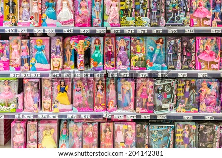 BUCHAREST, ROMANIA - JULY 09, 2014: Barbie Toys For Girls On Supermarket Stand. Barbie is a fashion doll manufactured by the American toy-company Mattel and launched in March 1959.