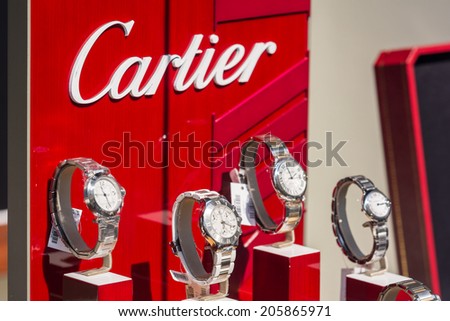 BUCHAREST, ROMANIA - JULY 18, 2014: Cartier Watches In Shop Window Display. Founded in Paris in 1847 it designs, manufactures, distributes and sells jewellery and watches.