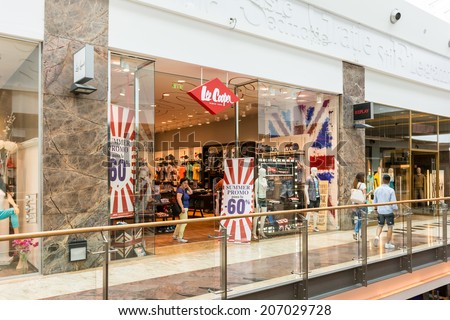 BUCHAREST, ROMANIA - JULY 24, 2014: People Buying Clothes In Lee Cooper Store. Lee Cooper is a British clothing company that licenses the sale of many branded items, including denim jeans.
