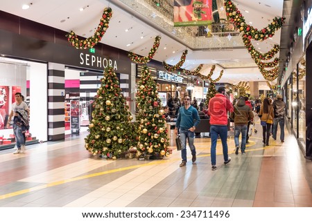 BUCHAREST, ROMANIA - NOVEMBER 30, 2014: People Shopping For Christmas In Luxury Shopping Mall Interior.