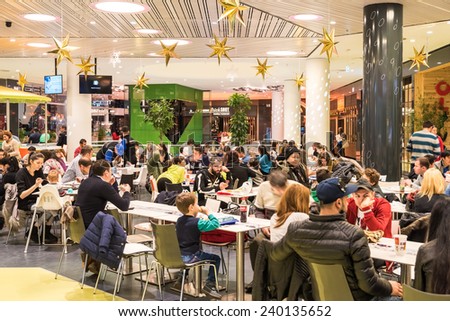 BUCHAREST, ROMANIA - DECEMBER 20, 2014: People Crowd Eating Fast Food On Restaurant Floor In Luxurious Shopping Mall.