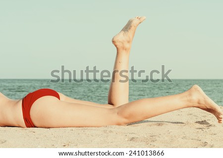 Retro Photo Of Girl Relaxing Her Feet On The Ocean Beach