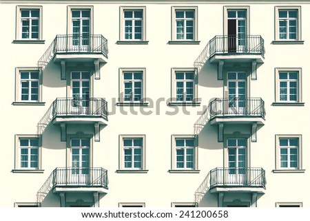 Retro Photo Of Apartment Complex Facade With Windows And Balconies