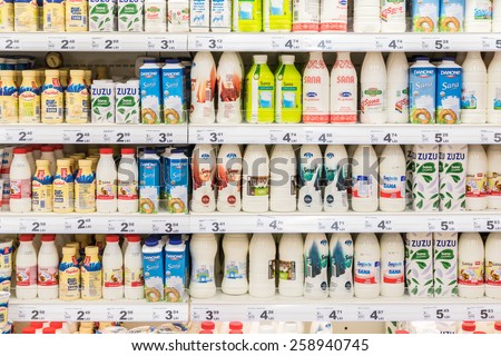 BUCHAREST, ROMANIA - MARCH 07, 2015: Fresh Milk Bottles On Supermarket Stand.