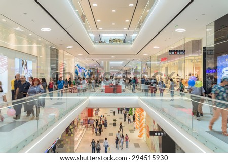 BUCHAREST, ROMANIA - JULY 06, 2015: People Crowd Rush In Shopping Luxury Mall Interior.