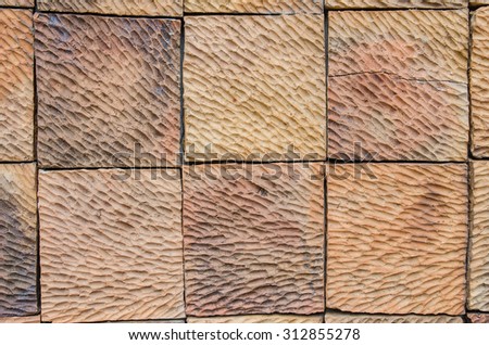 Abstract pattern of an old red, orange and black brick wall with lots of texture useful for backgrounds and wallpapers.