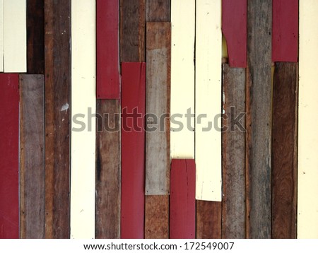 A colorful old wood-strip wall. The color of the wood are red, soft yellow, and the original wood texture.