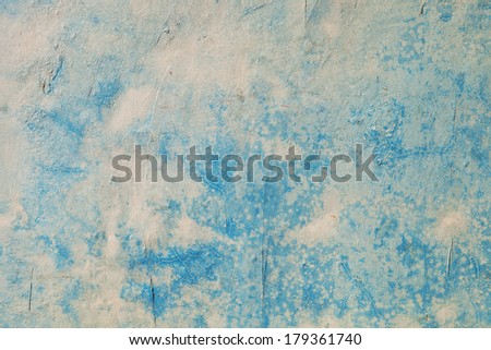 The old blue painted cement wall background of a  house, abrasive paint
