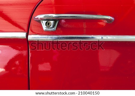door opener of old red car and the stainless steel strip, abstract wallpaper