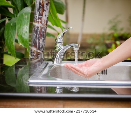 human hands being washed under pure water