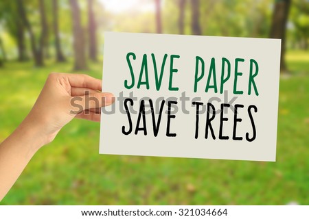 Hand holding a paper card with Save paper, Save trees word on abstract nature background