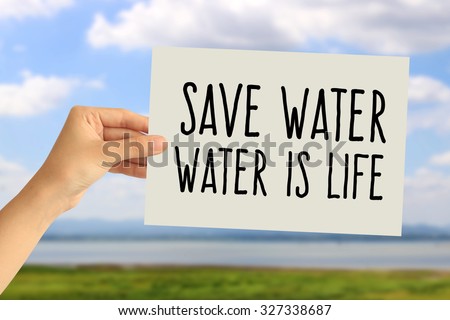 Hand holding a paper card with Save water, Water is life word on abstract nature background