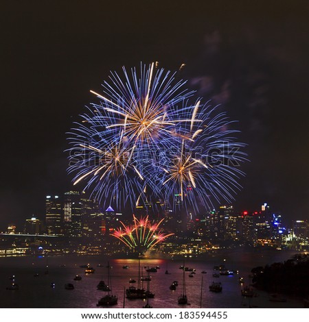 Australia Sydney New Year celebration FIreworks over city CBD with reflection in harbour waters view from Waverton