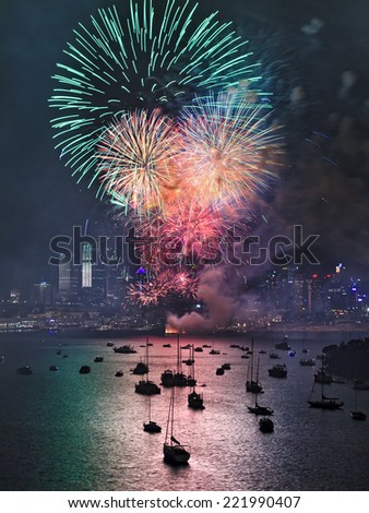 Australia SYdney New Year fireworks green color light balls over city CBD skyscrapers reflecting in harbour water