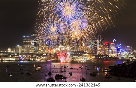 Australia Sydney city highlighted at New Year celebration fireworks with colourful fire balls above skyscrapers and harbour