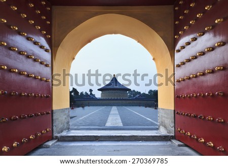 China, Beijing\' Garden of Heaven - residency of ancient chinese emperors. Red-gold imperial gates wide open towards round temple