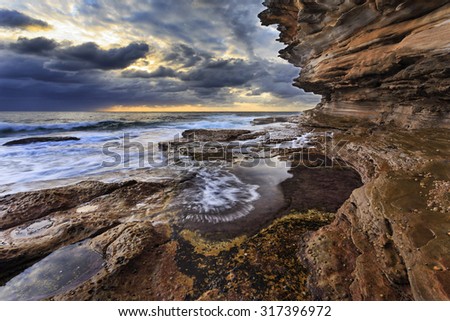 natural sandstone rocks forming high rising landscape at sea edge of coastal line in Sydney, Australia