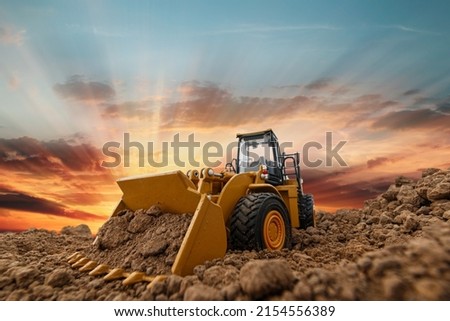 Selective focus with bucket,Wheel loader are digging the soil in the construction site on the sunset background . Photo stock © 