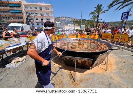 preparing a huge paella - spanish traditional food - javea, spain, july 2008