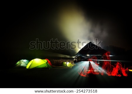 illuminated camping tents at night in alpin zone