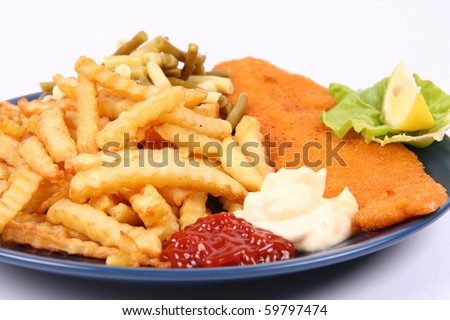 British cuisine: Fish and chips with some runner beans, ketchup and mayonnaise, decorated with lemon and lettuce