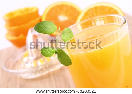Orange juice freshly squeezed from fresh fruits with a juicer