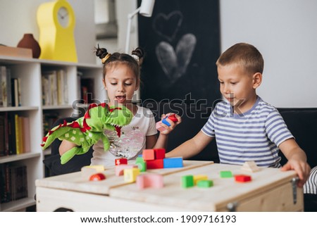 Similar – Image, Stock Photo Two children playing with their mobile on the beach