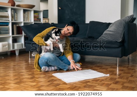 Similar – Image, Stock Photo Caucasian woman holding puppy. Adopted border collie dog held by a caucasian woman with long blond hair. Friendship and family.