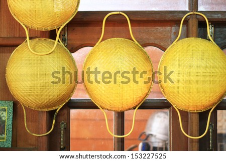 Bamboo sieves with handle hanging on window wall, hand made sieves