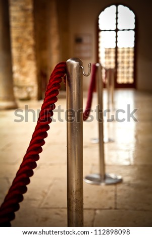 Red barrier rope on window background. event object