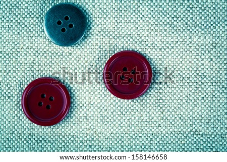 red buttons on the old clothes
