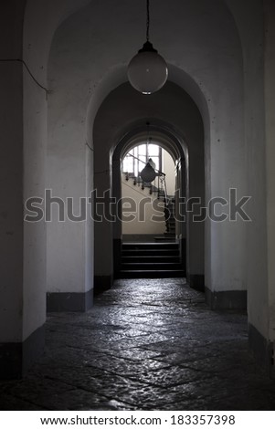 Old home doorway with stairs, shadow and white wall. architectural detail