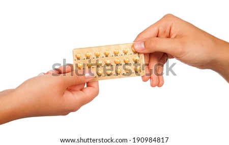 young woman holding birth control pills