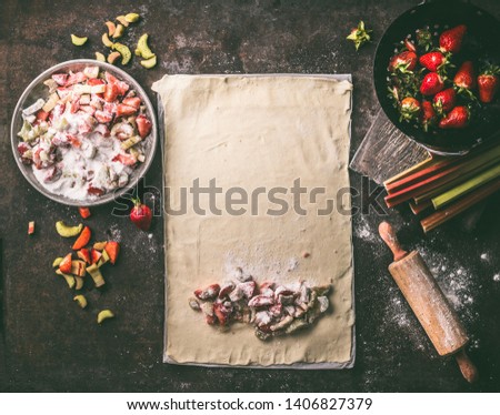 Similar – Image, Stock Photo Strawberry rhubarb strudel cake on light mint kitchen table with knife and ingredients. Top view. Homemade seasonal baking