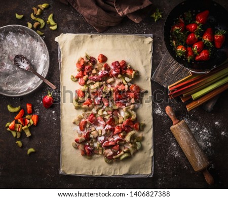 Similar – Image, Stock Photo Strawberry rhubarb strudel cake on light mint kitchen table with knife and ingredients. Top view. Homemade seasonal baking