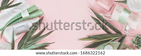 Modern skin care beauty and cosmetics concept with products bottles with mock up, aloe vera and palm leaves on pastel pink background. Natural cosmetic. Banner. Top view. Eco friendly. Zero waste. ストックフォト © 