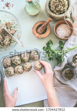 Image, Stock Photo Female hand make buckwheat balls on kitchen table background with herbs and spices, top view. Healthy homemade food