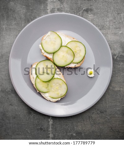 cucumber sandwiches in plate on gray table