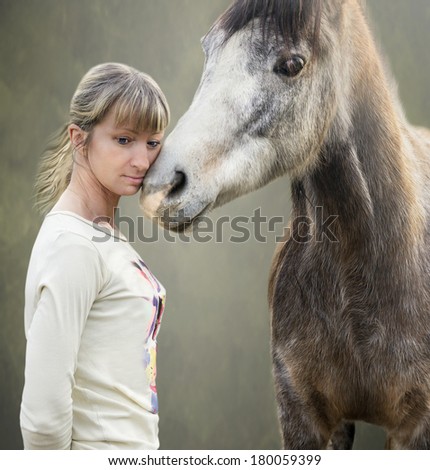 gray brown horse cuddles with blonde woman