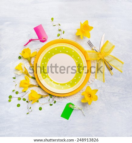 Plate with spring flowers frame, knife, fork, ribbon and sign , top view , place for text