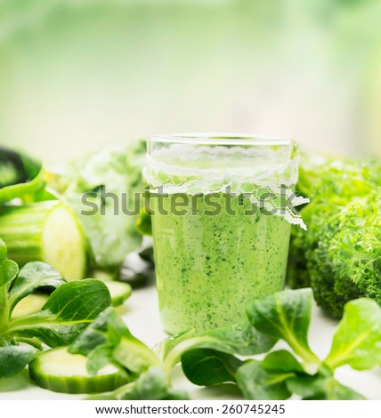 glass of green herbs and vegetables smoothie, close up