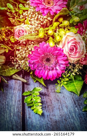 Flowers bunch with gerbera and roses on blue wooden background, textured