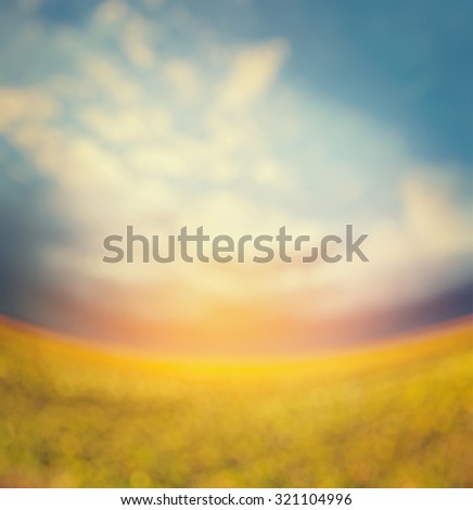 blurred nature background with sun light, field or pasture and beautiful sky